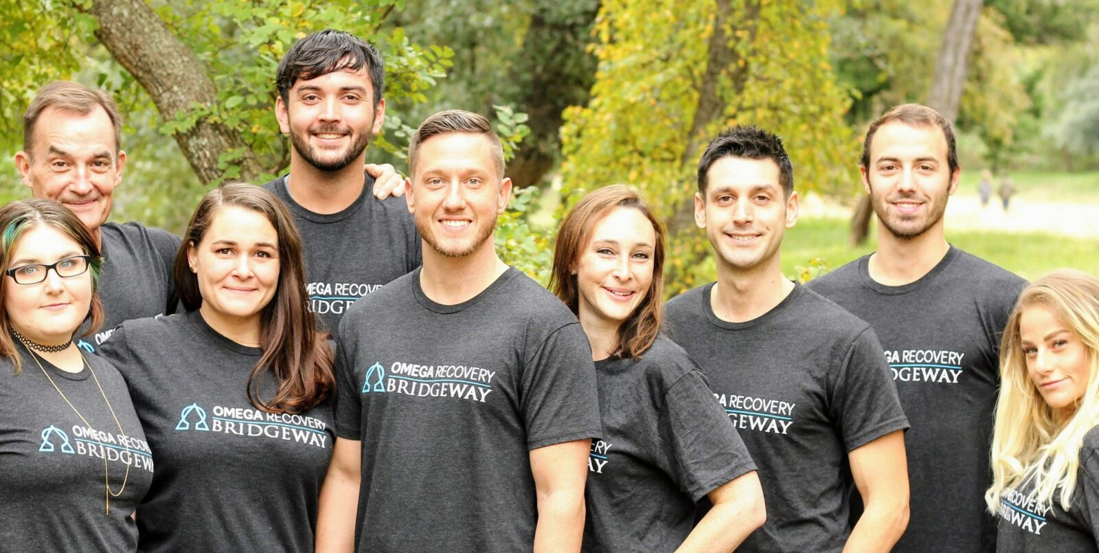 Group indoor photo of the team in Bridgeway t-shirts